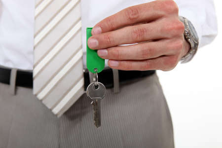man in a suit holding a keyの写真素材