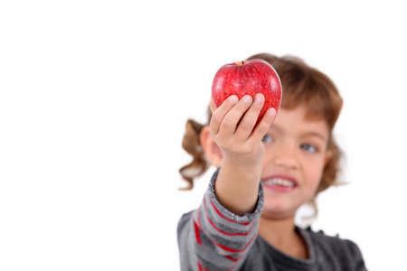 Little girl holding red appleの写真素材