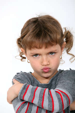 Angry little girl grinningの写真素材