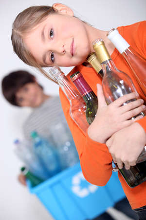 Children recycling glass bottlesの写真素材