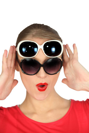 Woman wearing two pairs of sunglasses