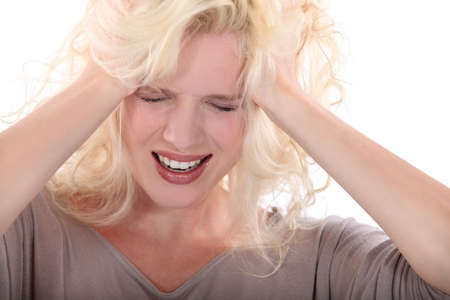Blond woman suffering from headacheの写真素材