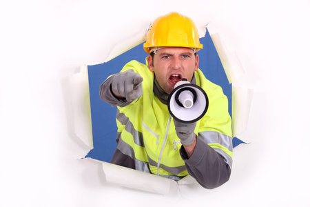 Builder shouting through megaphoneの写真素材