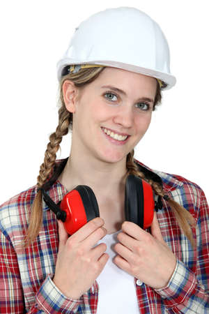 young craftswoman wearing earphonesの写真素材