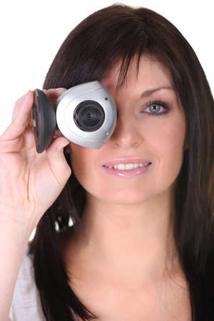 Young woman holding webcam on white backgroundの写真素材