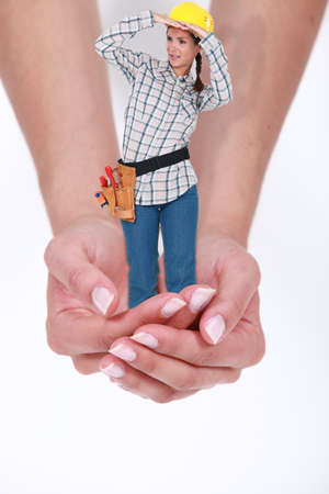 Hands carrying undersized female laborerの写真素材