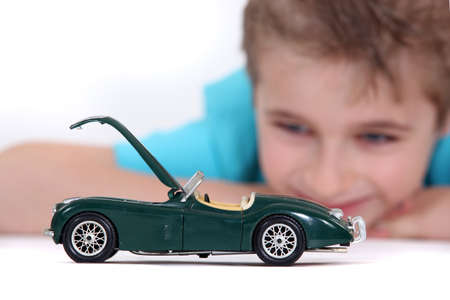 Little boy watching a toy carの写真素材