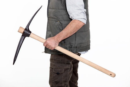 bricklayer holding pickaxe in studioの写真素材