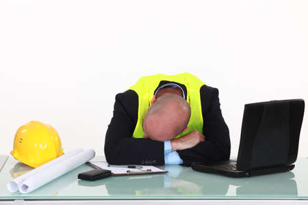 tired architect sleeping in officeの写真素材
