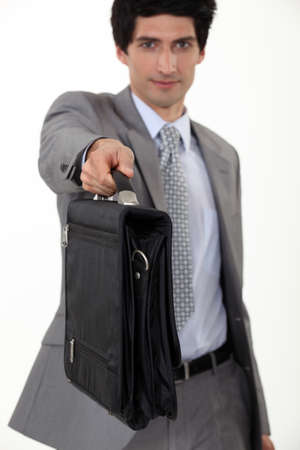Businessman giving his briefcaseの写真素材