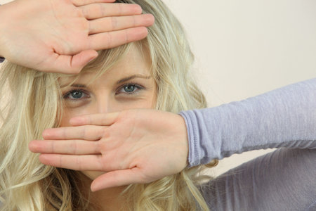 Woman covering face with hands