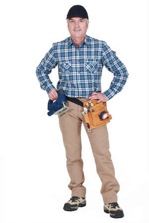 Middle-aged worker with band-sawの写真素材