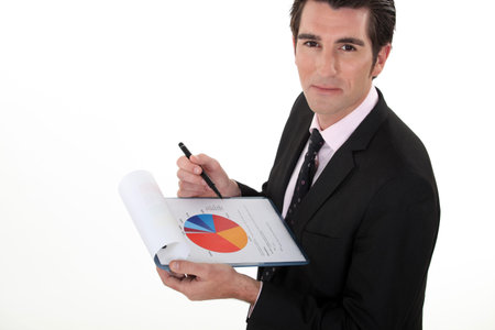 Man holding pie-chart and penの写真素材