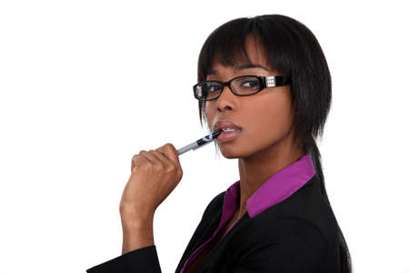 Businesswoman chewing on her penの写真素材