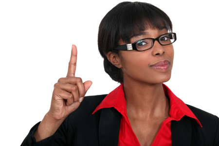 Woman holding her index finger upの写真素材