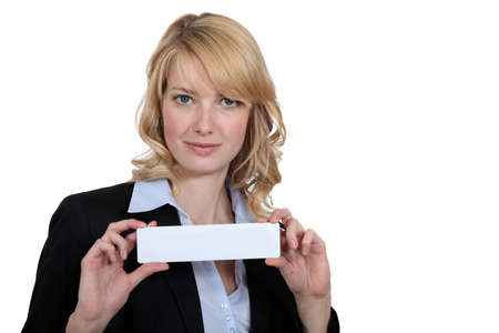 Blond businesswoman holding calling cardの写真素材