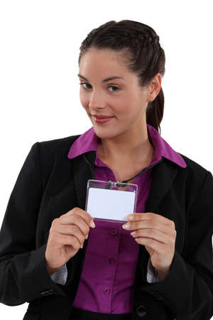 Woman proudly displaying visitors badgeの写真素材
