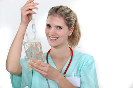 Nurse hooking up an IVの写真素材