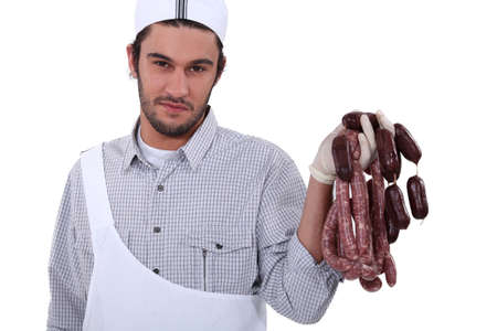 Butcher holding sausagesの写真素材