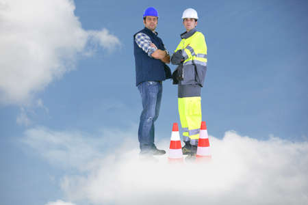 Photo-montage of building workers standing on a cloudの写真素材