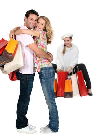 Three people with shopping bagsの写真素材