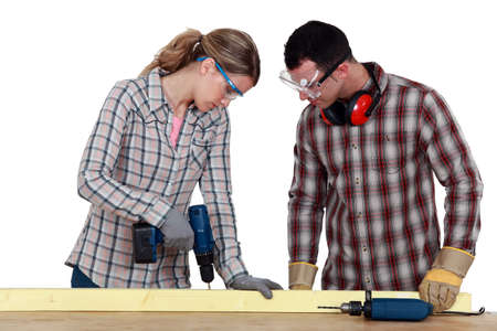 Couple drilling woodの写真素材