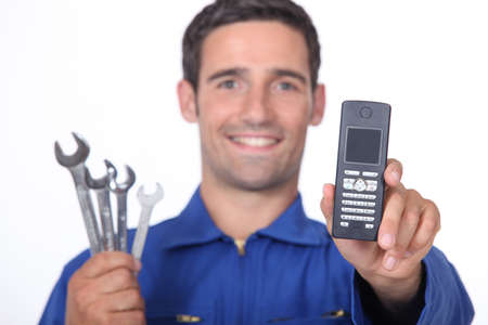 Mechanic showing mobile phoneの写真素材