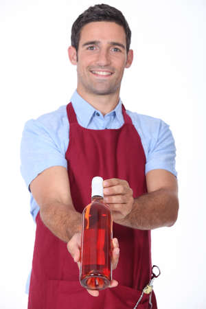 Waiter offering bottle of wineの写真素材
