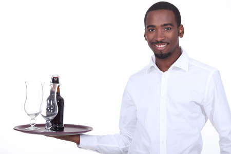 Waiter with beer on a trayの写真素材
