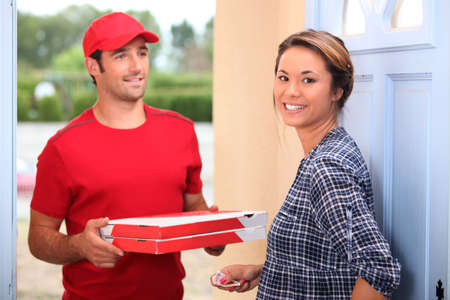 young man delivering pizzaの写真素材