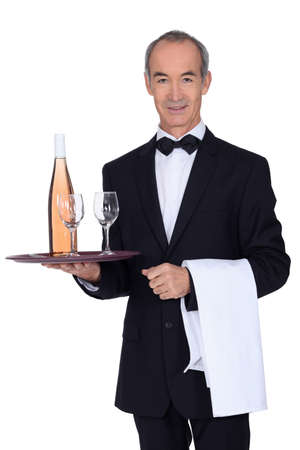 Senior waiter holding trayの写真素材