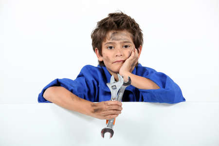 Boy dressed as a dirty mechanicの写真素材
