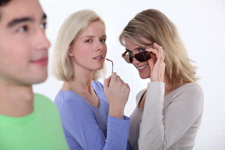 Women checking out a young manの写真素材
