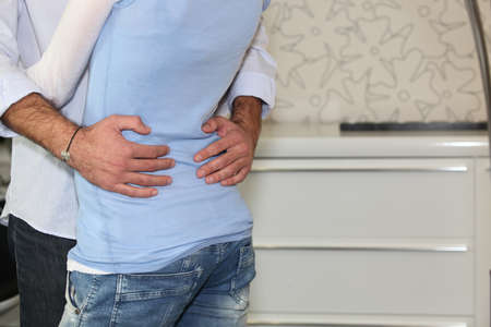 Close-up of affectionate couple hugging at homeの写真素材