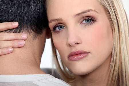 A cute blond comforting her boyfriend の写真素材