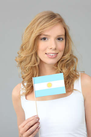 Woman waving an Argentinean flagの写真素材