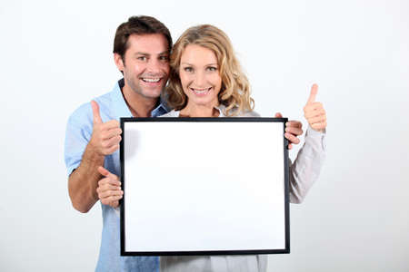 woman and man holding boardの写真素材
