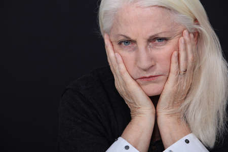 Old woman coping with lossの写真素材