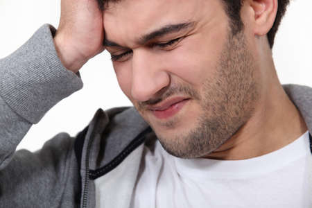 Man suffering from a throbbing headacheの写真素材