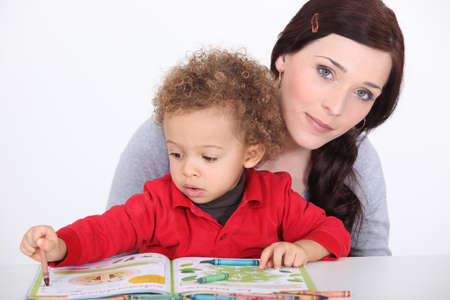 Mother and son reading book togetherの写真素材