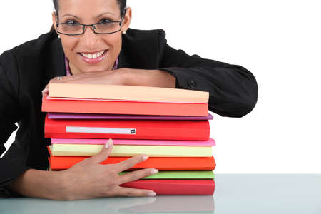 Secretary with a stack of foldersの写真素材