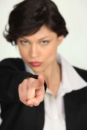 Strong businesswoman pointing at the cameraの写真素材