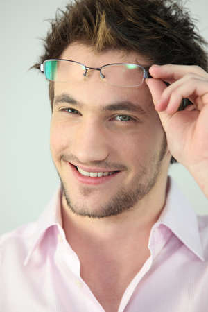 Portrait of a man taking his glasses offの写真素材