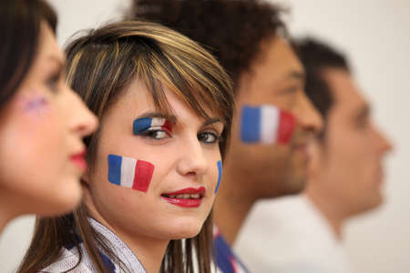 Friends watching the French team play a soccer gameの写真素材