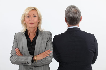 Smart mature businesswoman next to businessmanの写真素材