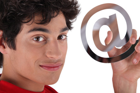 young dark-haired boy holding at signの写真素材