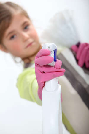 Little girl spraying cleaning productの写真素材