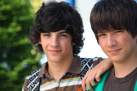 two teenagers posing