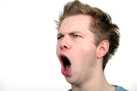 man shouting against studio backgroundの写真素材