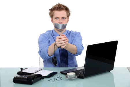 Man being held prisoner in the officeの写真素材